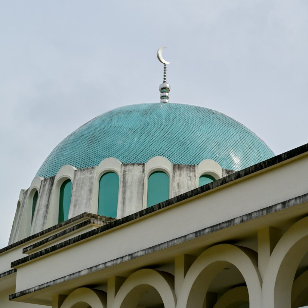 A mosque's dome is topped with a crescent moon.